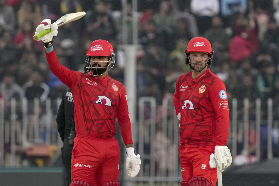 Islamabad United' Shadab Khan, left, celebrates after scoring fifty as Colin Munro watches during the Pakistan Super League T20 cricket match between Islamabad United and Multan Sultans, in Rawalpindi, Pakistan, Sunday, March 10, 2024. (AP Photo/Anjum Naveed)