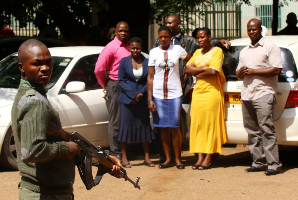 Police stand guard in Harare as people arrested during the protests await a court appeal hearing on Friday (Philimon Bulawayo/Reuters)