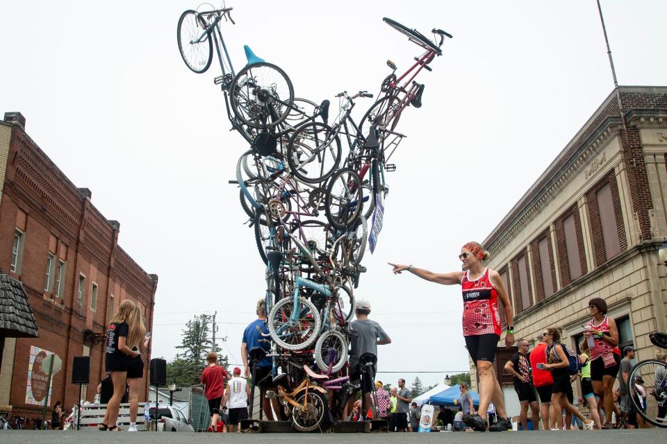 RAGBRAI cyclists pose for photos by a tornado sculpture made of bicycles in 2021.