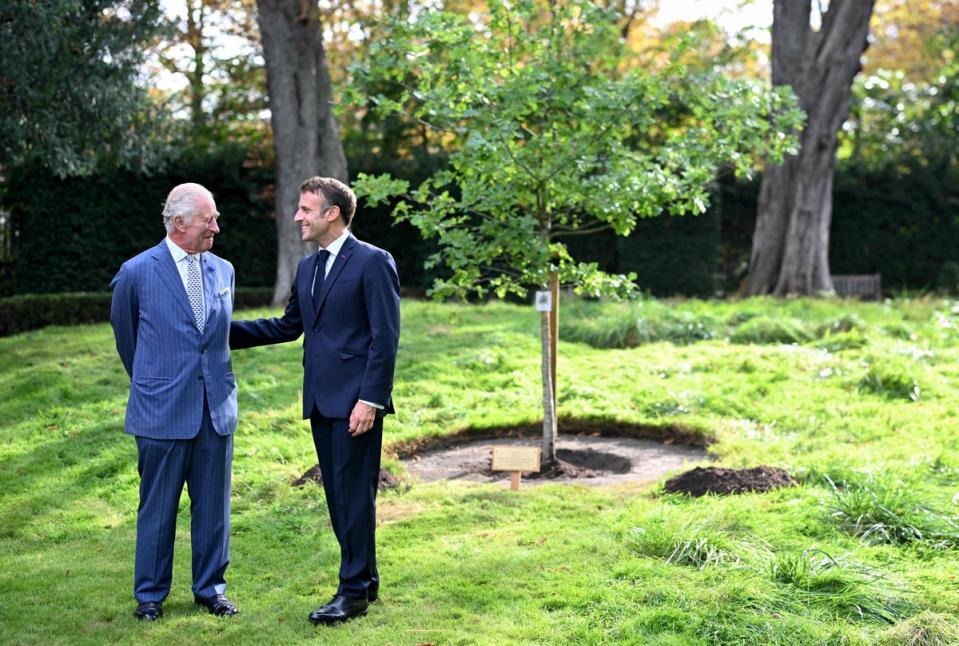 Britain’s King Charles III (left) and French President Emmanuel Macron take  part in an oak tree planting ceremony to commemorate the visit in the garden of the British Ambassador’s residence in Paris (POOL/AFP/Getty)