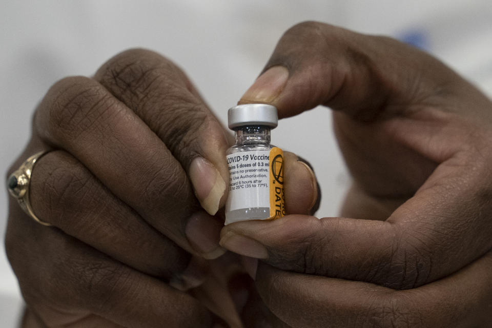 Dr. Michelle Chester holds a vial of Healthcare worker Sandra Lindsay's Pfizer-BioNTech Covid-19 vaccine. (Photographer: Mark Lennihan/AP Photo/Bloomberg via Getty Images)