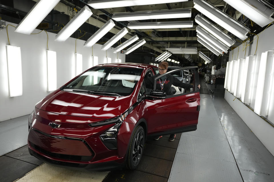 File - Assembly line worker Janice DeBono looks over a 2023 Chevrolet Bolt EUV at the General Motors Orion Assembly, June 15, 2023, in Lake Orion, Mich. Government tallies show only 11 of the more than 50 EVs on sale in the U.S. are eligible for tax credits so far this year. Still qualifying for credits are the Tesla Model Y SUV, Chevrolet Bolt compact car and Rivian R1T pickup truck. (AP Photo/Carlos Osorio, File)