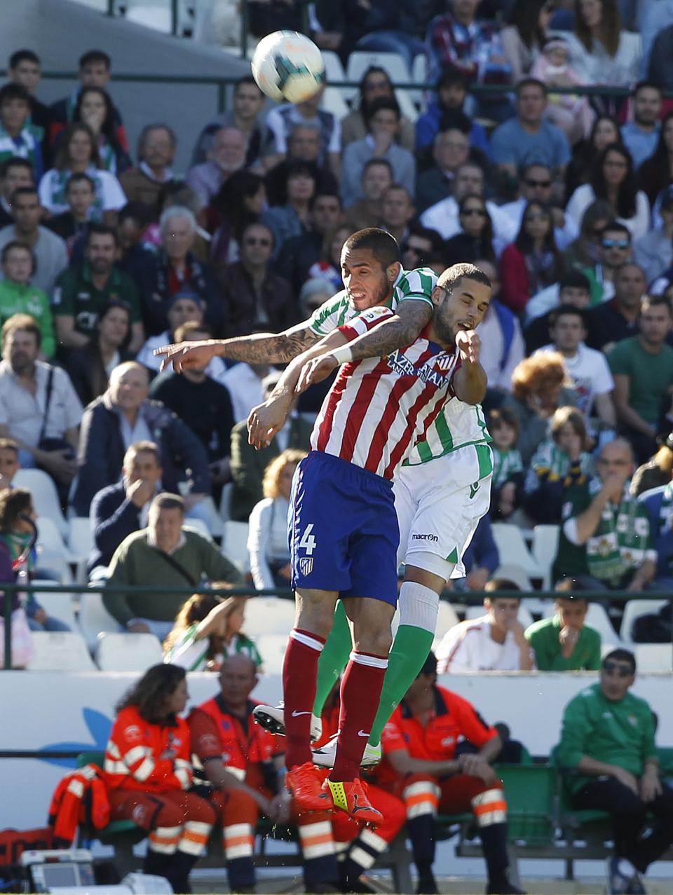 Atletico de Madrid's Mario Suarez, front, and Betis' Braian Rodriguez, behind, fight for the ball during their La Liga soccer match at the Benito Villamarin stadium, in Seville, Spain on Sunday, March 23, 2014. (AP Photo/Angel Fernandez)