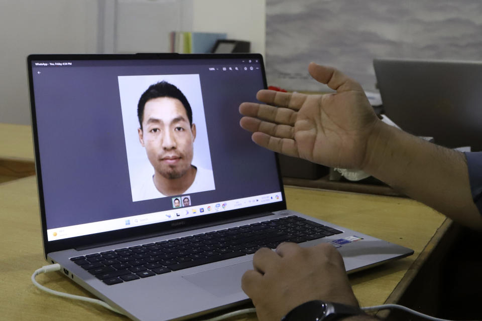 Nizamuddin, manager of Adventure Tours Pakistan, displays a picture of Japanese climber Atsushi Taguchi, who is missing while he and another climber were scaling the Spantik Peak, also known as Golden Peak, on his laptop at his office in Skardu, Pakistan, Sunday, June 16, 2024. A search is still underway to find Taguchi, while rescuers have found and retrieved the body of Ryuseki Hiraoka, who has died while trying to scale one of the highest mountains in northern Pakistan, officials said. (AP Photo/M.H. Balti)