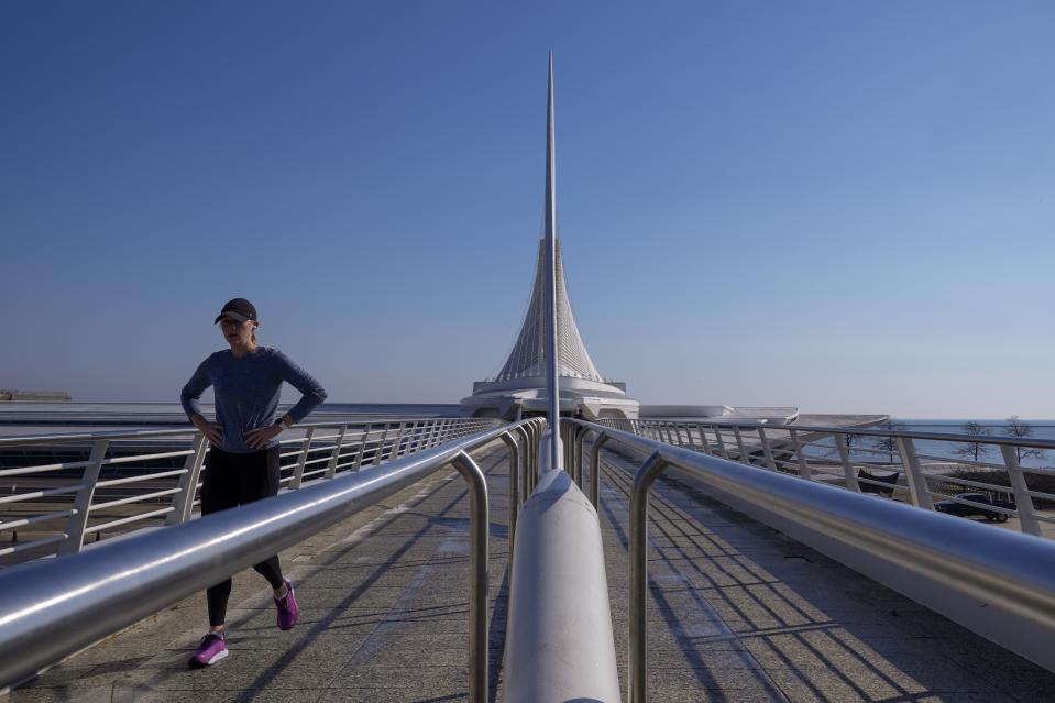 FILE - A woman walks near the Milwaukee Art Museum as she enjoys warm weather Tuesday, Feb. 27, 2024, in Milwaukee. Federal meteorologists on Friday, March 8, have made it official: It's the warmest U.S. winter on record by far. (AP Photo/Morry Gash, File)