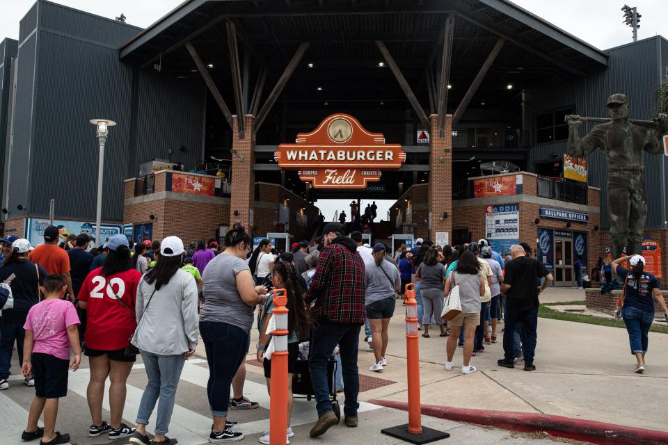 A crowd gathers at the entrance of Whataburger Field before a Hooks game featuring a jersey giveaway and the Astros World Series Championship trophy, Saturday, April 22, 2023, in Corpus Christi, Texas.