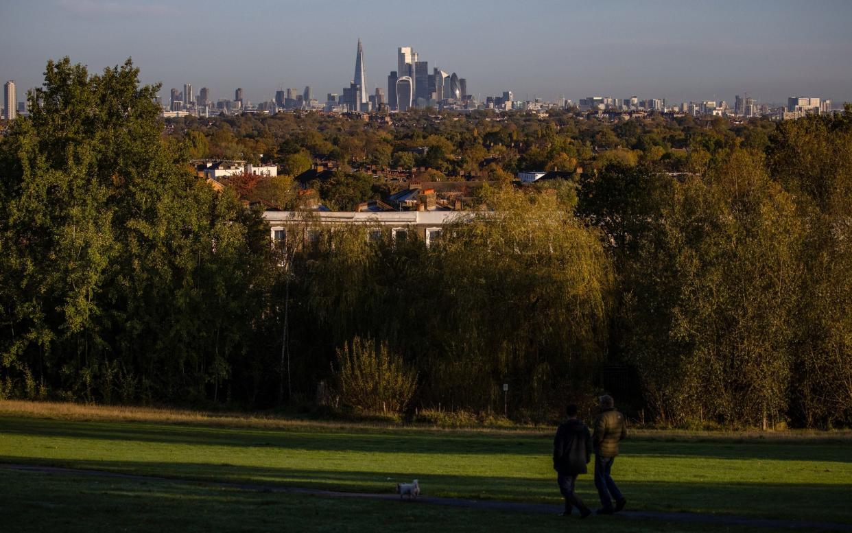 Wellbeing is a better measure of national success than GDP, scientists have argued, and prioritising it could help tackle climate change - Simon Dawson /Bloomberg 