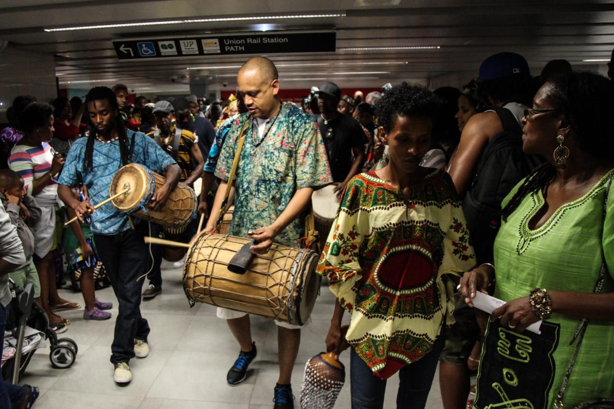 Participants of the annual underground freedom train perform with djembe drums at Union Station in Toronto to commemorate Emancipation Day. Photo from CP Images