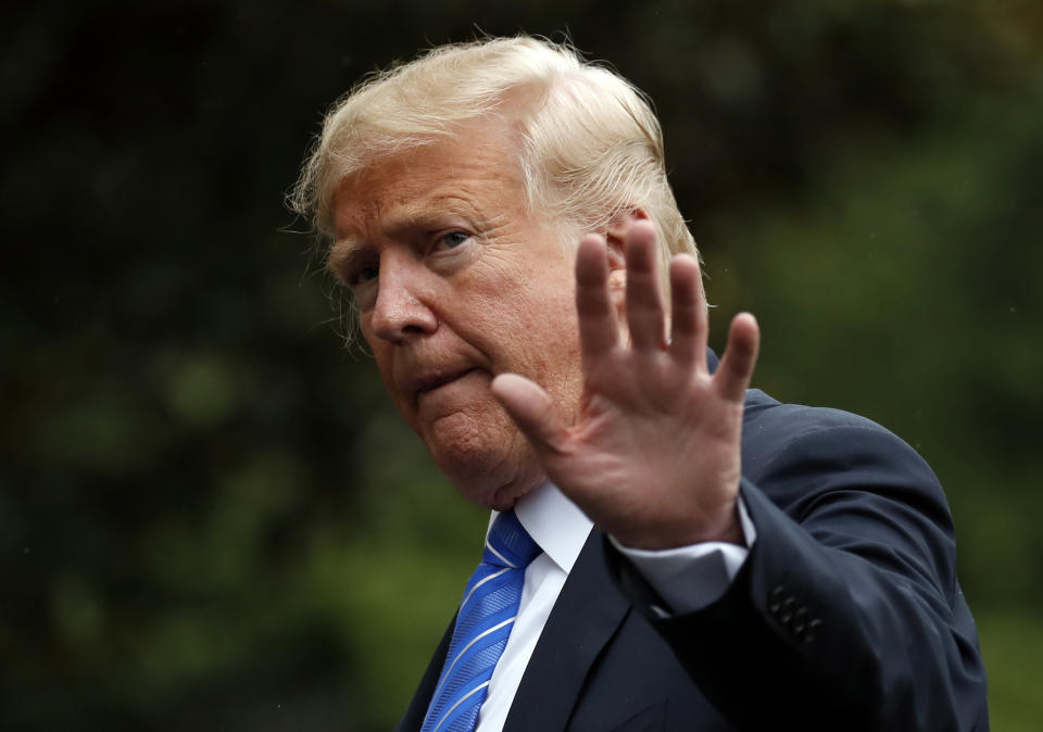 FILE - In this Tuesday, July 24, 2018, file photo, President Donald Trump waves as he walks on the South Lawn after stepping off Marine One at the White House, in Washington. Trump was recorded by his longtime personal lawyer discussing a potential payment for a former Playboy model's account of having an affair with him, and at one point can be heard saying "pay with cash." (AP Photo/Alex Brandon, File)