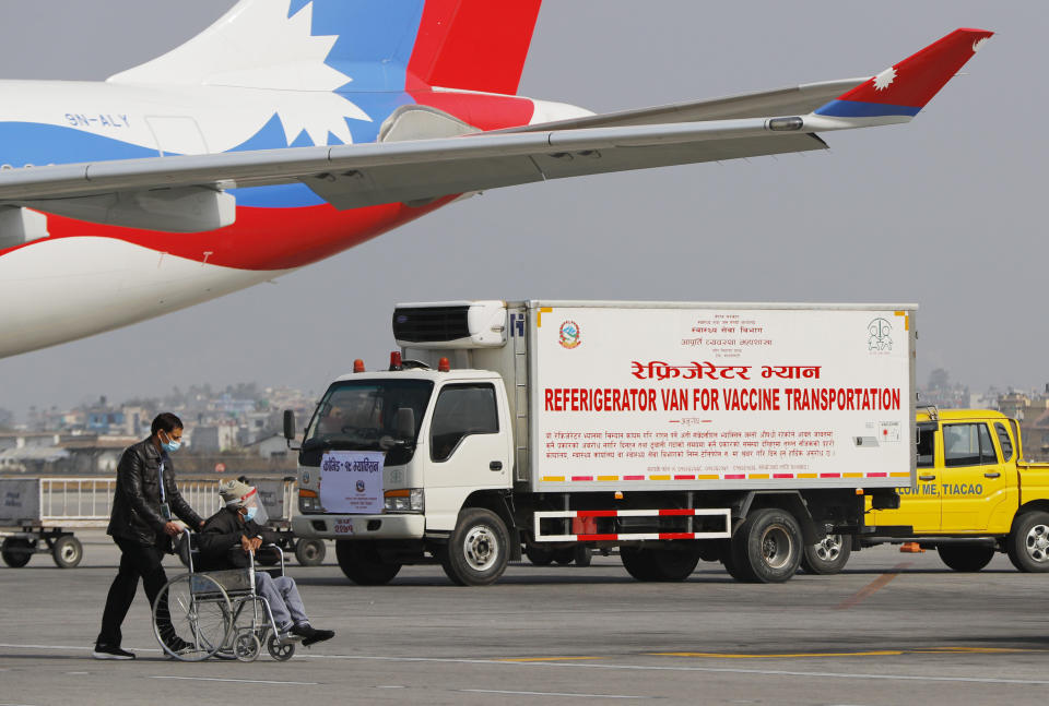 A van stands parked waiting to transport AstraZeneca/Oxford University vaccines, manufactured under license by Serum Institute of India, at Tribhuwan International Airport in Kathmandu, Nepal, Thursday, Jan. 21, 2021. India sent 1 million doses of a coronavirus vaccine to Nepal on Thursday, a gift that is likely to help repair strained ties between the two neighbors. (AP Photo/Niranjan Shrestha)