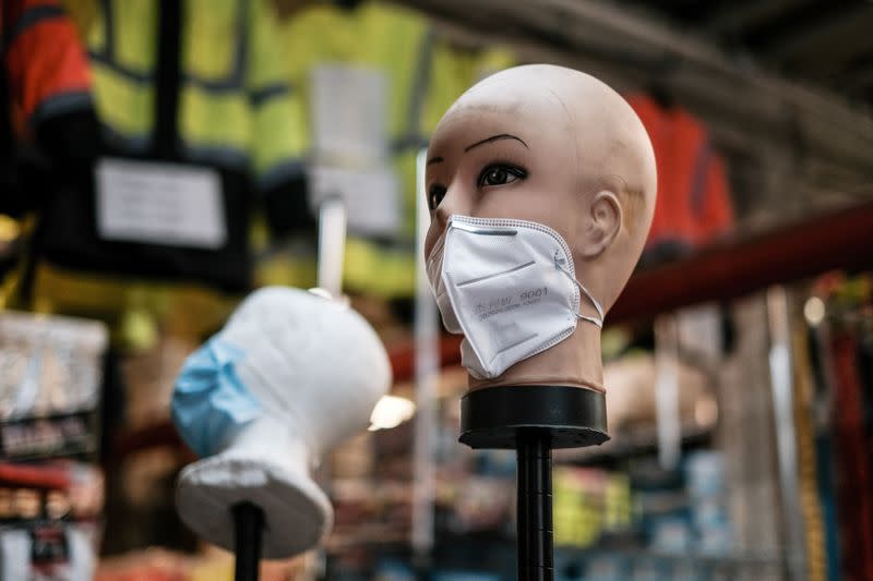 FILE PHOTO: A mannequin displays disposable face masks at a safety equipment store in the Brooklyn borough of New York City, U.S.