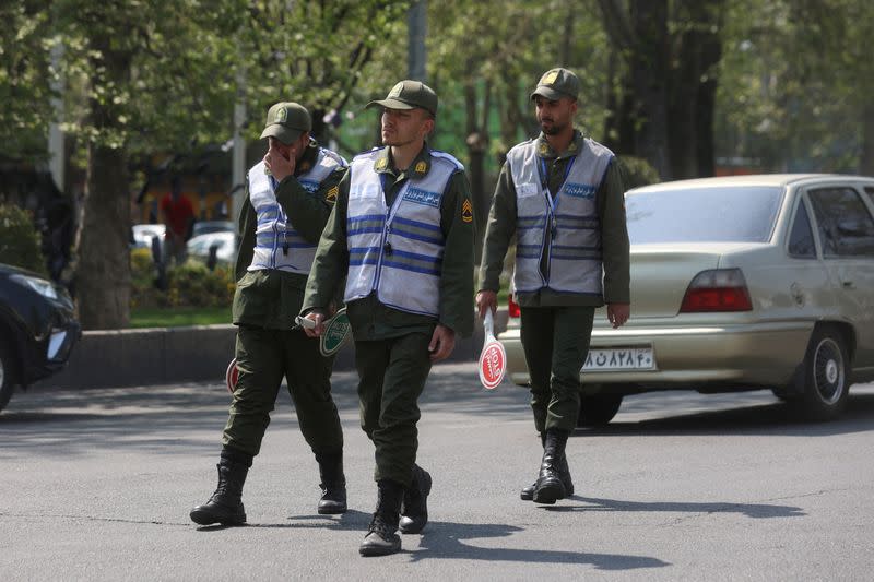 FILE PHOTO: People walk on a street amid the implementation of the new hijab surveillance in Tehran