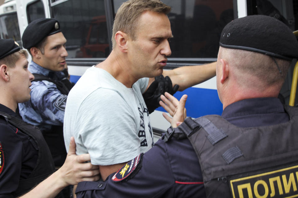 Russian police detain opposition leader Alexei Navalny, during a march in Moscow, Russia, Wednesday, June 12, 2019. Police and hundreds of demonstrators are facing off in central Moscow at an unauthorized march against police abuse in the wake of the high-profile detention of a Russian journalist. More than 20 demonstrators have been detained, according to monitoring group. (Artemie Mindrin,Rain TV Channel via AP)