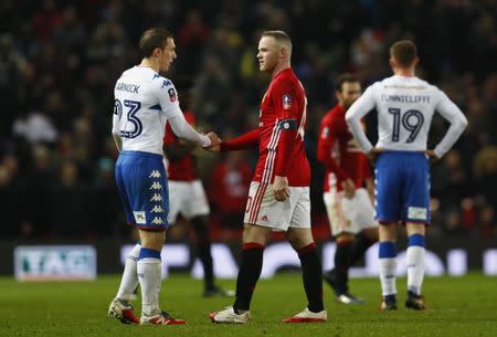 Britain Football Soccer - Manchester United v Wigan Athletic - FA Cup Fourth Round - Old Trafford - 29/1/17 Manchester United's Wayne Rooney and Wigan Athletic's Stephen Warnock shake hands at the end of the match Action Images via Reuters / Jason Cairnduff Livepic EDITORIAL USE ONLY. No use with unauthorized audio, video, data, fixture lists, club/league logos or "live" services. Online in-match use limited to 45 images, no video emulation. No use in betting, games or single club/league/player publications. Please contact your account representative for further details.