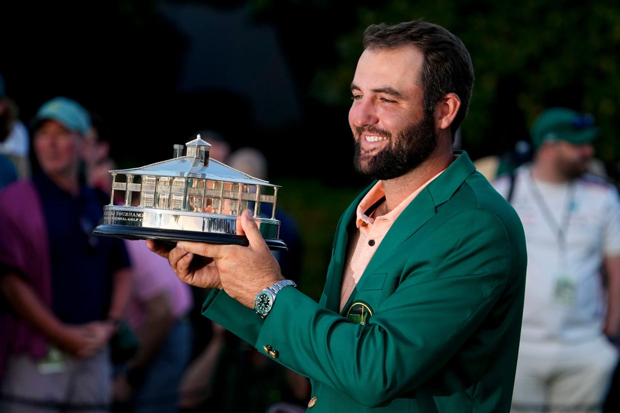 Texas ex Scottie Scheffler holds up his Masters trophy at the green jacket ceremony after capturing his second title at Augusta in three years. Former UT golfers have now won 10 majors.