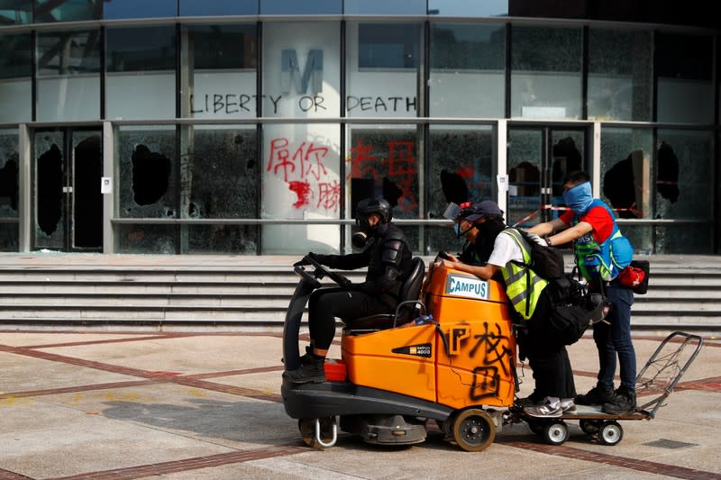 Student protesters drive a road sweeper during a demonstration at Hong Kong Polytechnic University Campus, Hong Kong