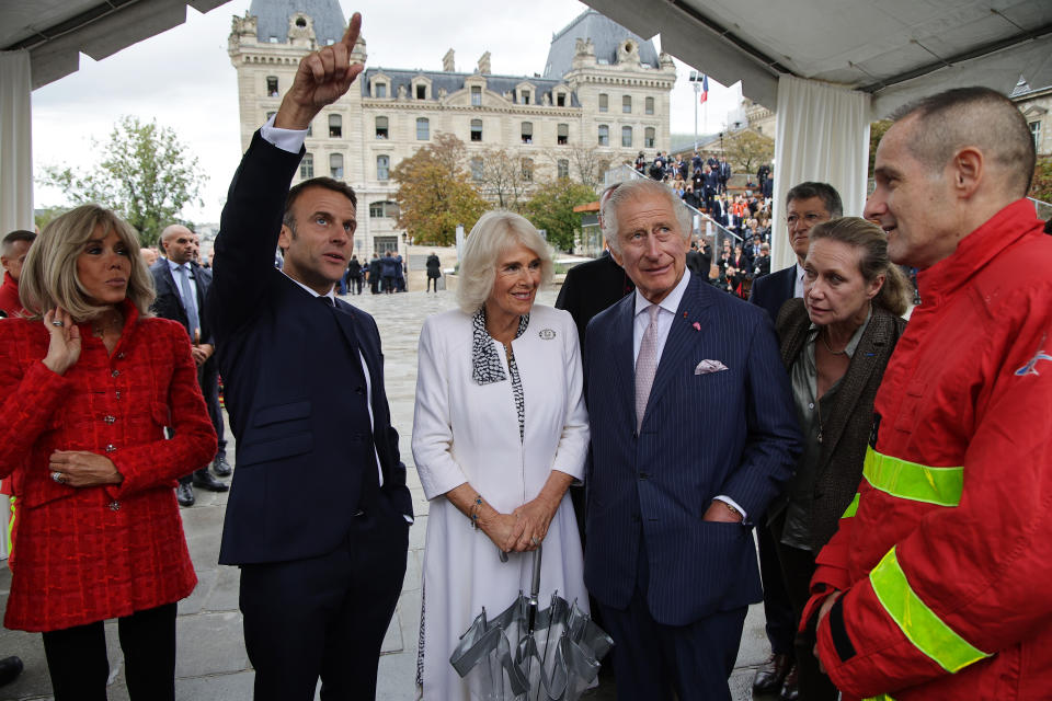 Britain's King Charles III, Queen Camilla, French President Emmanuel Macron, second left, and his wife Brigitte Macron meet firefighters during a visit on the Notre-Dame Cathedral rebuilding site in Paris, Thursday, Sept, 21 2023. On the second day of his state visit to France, King Charles met with sports groups in the northern suburbs of Paris and pays a visit to fire-damaged Notre-Dame cathedral. (Christophe Petit Tesson, Pool via AP)