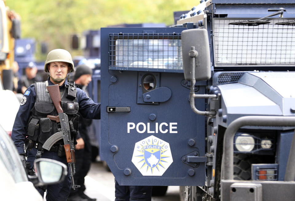 Kosovo special police with armored vehicles stand on the road near the northern Kosovo border crossing of Jarinje, Monday, Sept. 20, 2021. Tensions have soared on the border between Kosovo and Serbia as Pristina authorities started implementing a rule to remove Serbian license plates from cars entering Kosovo. Kosovo special police with armored vehicles were deployed Monday on the tense border as hundreds of Kosovo Serbs reportedly drove there in their cars to protest the move. (AP Photo/Bojan Slavkovic)