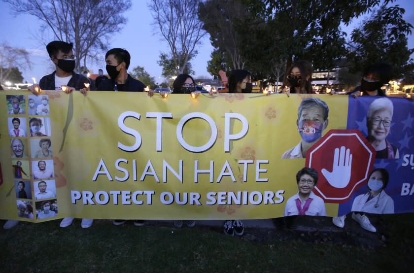 Local residents came out to a candlelight vigil to stop Asian hate, at Community Center Park, in Garden Grove on Tuesday, March 23, 2021.