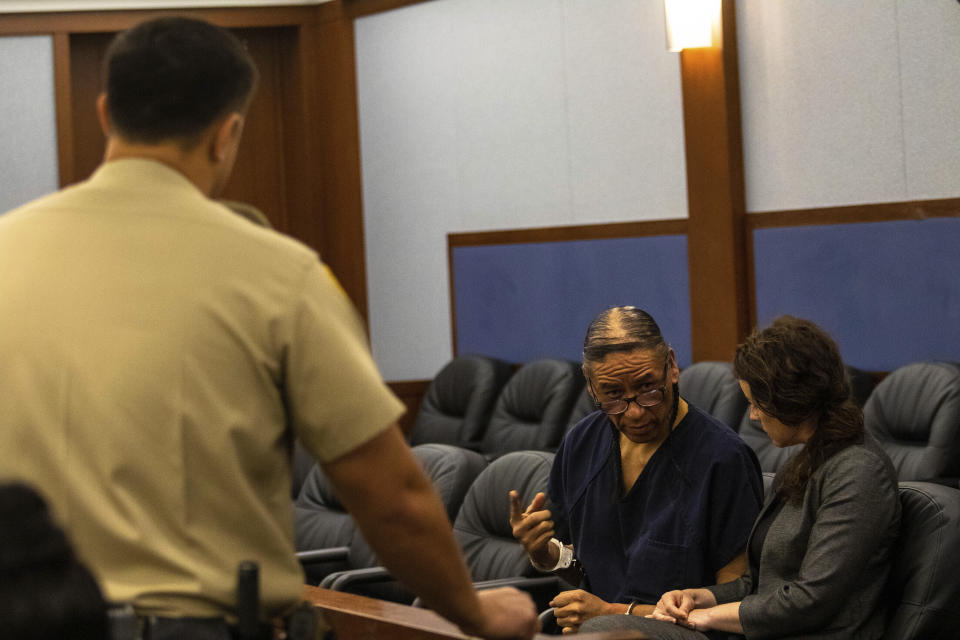 Nathan Chasing Horse speaks with Kristy Holsten, Clark County public defender, in Las Vegas, on Monday, April 3, 2023. Clark County District Judge Carli Kierny postponed the trial for the former “Dances With Wolves” actor indicted in state court on charges that he sexually abused Indigenous women and girls for a decade in the Las Vegas area. (AP Photo/Ty O'Neil)