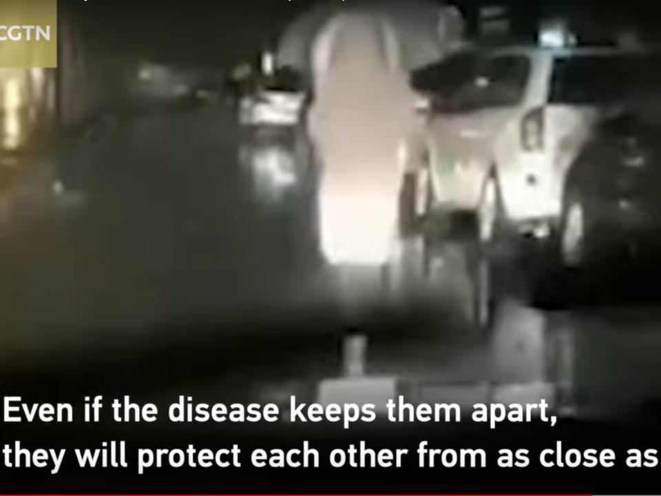 husband drives behind his wife as she walks to wuhan hospital at night