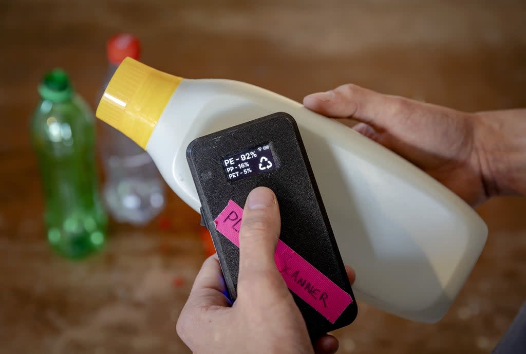 Dutch student Jerry de Vos shows his invention, a plastic scanner that identifies what type of plastic a product is made of, for which he was awarded the 2021 James Dyson award for Sustainability (ANP/AFP via Getty Images)