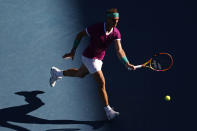 Rafael Nadal of Spain plays a forehand return to Denis Shapovalov of Canada during their quarterfinal match at the Australian Open tennis championships in Melbourne, Australia, Tuesday, Jan. 25, 2022. (AP Photo/Tertius Pickard)