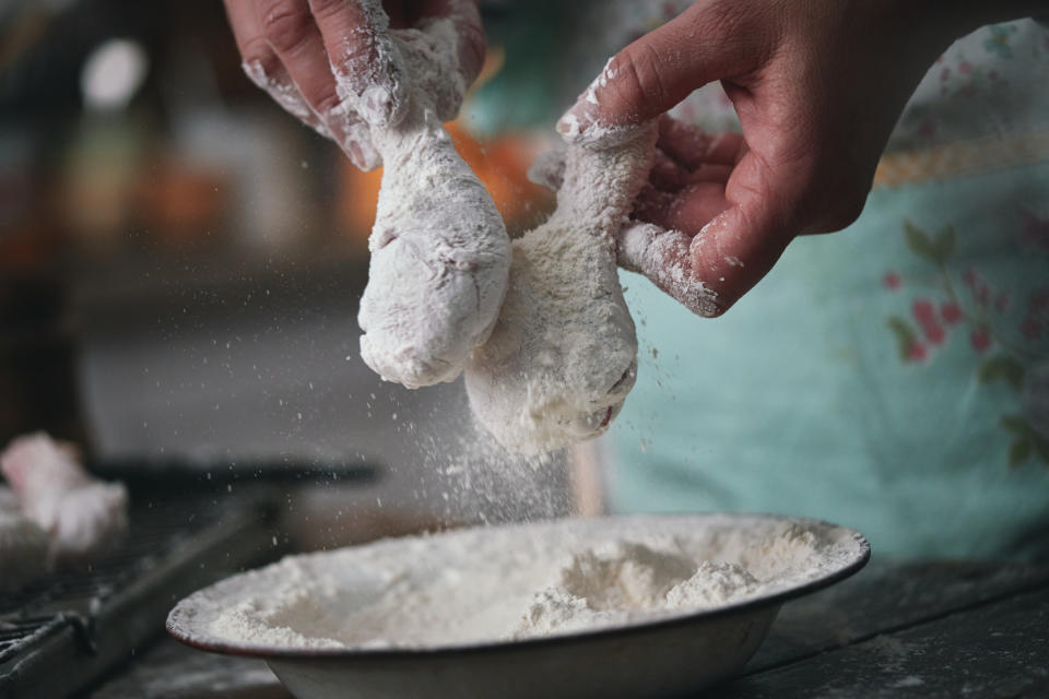 Someone making fried chicken