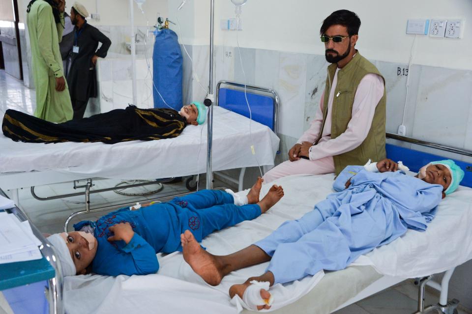 At least three people were killed and about 20 children wounded when a Taliban truck bomb detonated on Oct. 16 near a rural police station and partially destroyed a nearby religious school, Afghan officials said. Children are seen receiving medical treatment in a hospital. (Photo: NOORULLAH SHIRZADA via Getty Images)