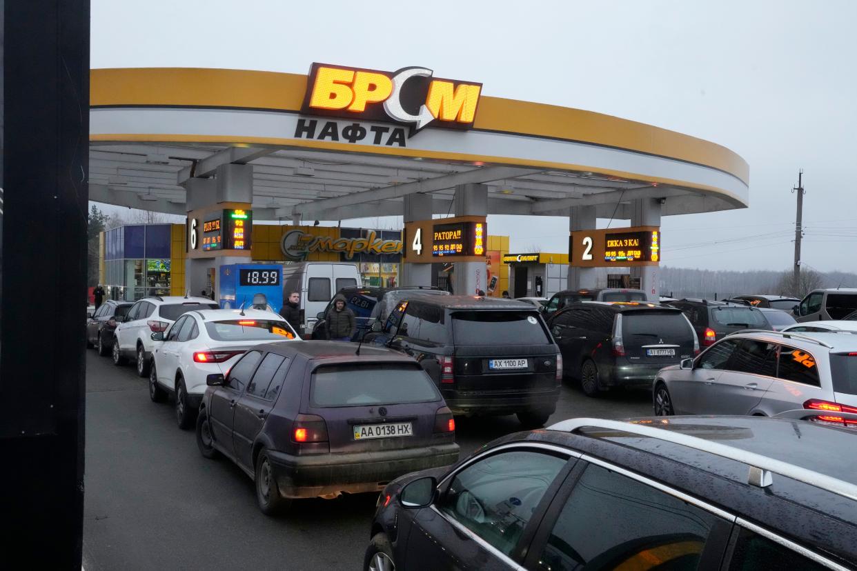 Vehicles line up to a gasoline station in Kyiv, Ukraine, Thursday, Feb. 24, 2022. Russian troops have launched their anticipated attack on Ukraine. Big explosions were heard before dawn in Kyiv, Kharkiv and Odesa, as world leaders decried the start of an Russian invasion that could cause massive casualties and topple Ukraine's democratically elected government.