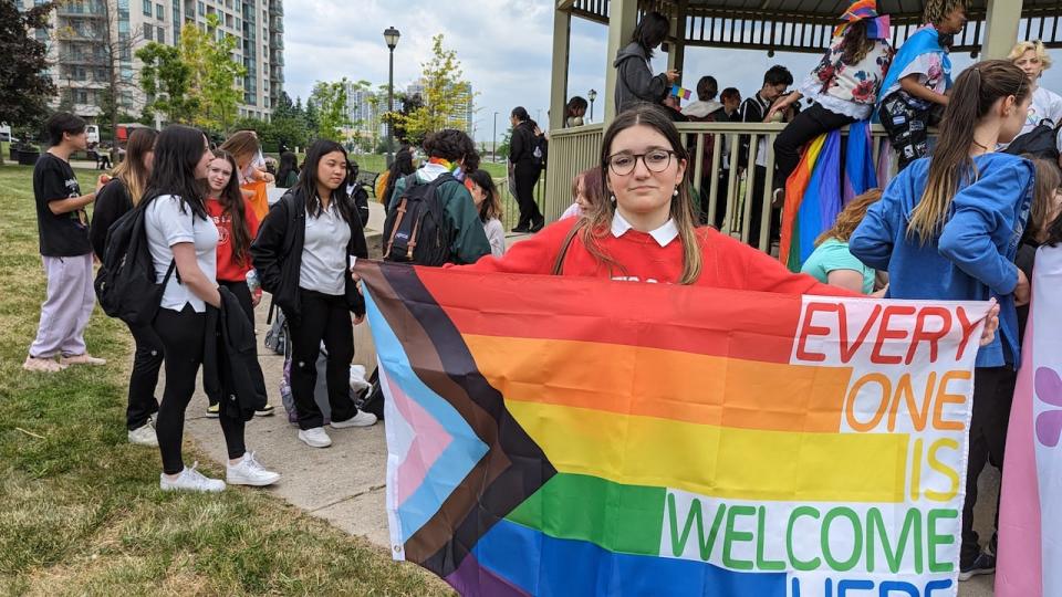 Student Erika Cordeiro holds a Pride flag outside of St. Elizabeth Catholic High School in Vaughan, Ont., where students walked off of school grounds to protest the York Catholic District School Board's decision not to fly the flag. 