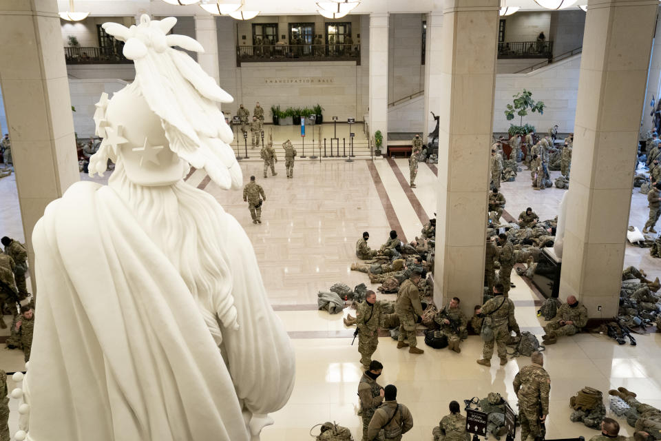 WASHINGTON, DC - JANUARY 13: Members of the National Guard rest in the Visitor Center of the U.S. Capitol on January 13, 2021 in Washington, DC. Security has been increased throughout Washington following the breach of the U.S. Capitol last Wednesday, and leading up to the Presidential inauguration. (Photo by Stefani Reynolds/Getty Images)