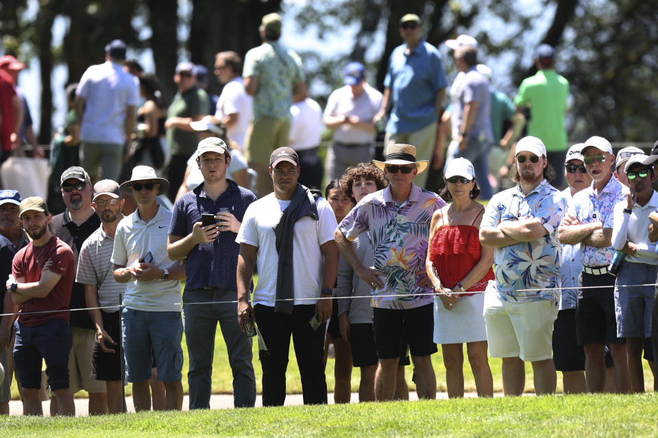 People watch golfers on the third green during the first round of the Portland Invitational LIV Golf tournament in North Plains, Ore., Thursday, June 30, 2022. (AP Photo/Steve Dipaola)