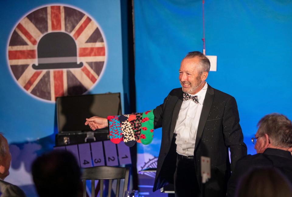 Dan Sperling cracks a big smile as he performs a magic trick in front of a large audience during the Magic Soiree inside Camp Ticonderoga in Troy on Saturday, Sept. 30, 2023. Sperling has been performing magic for 40 years.