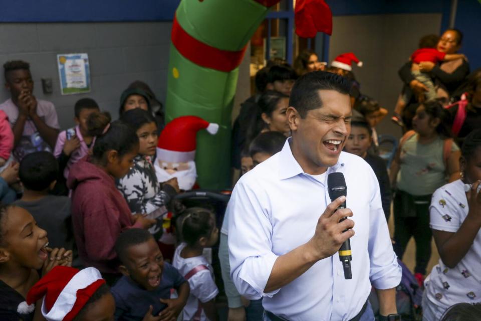 Assemblymember and City Council candidate Miguel Santiago speaks at a Boyle Heights toy giveaway in December.