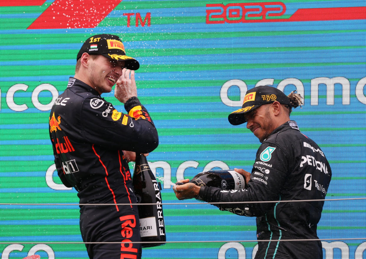 Formula One F1 - Hungarian Grand Prix - Hungaroring, Budapest, Hungary - July 31, 2022 Red Bull's Max Verstappen celebrates on the podium with sparkling wine after winning the race with second placed Mercedes' Lewis Hamilton REUTERS/Bernadett Szabo