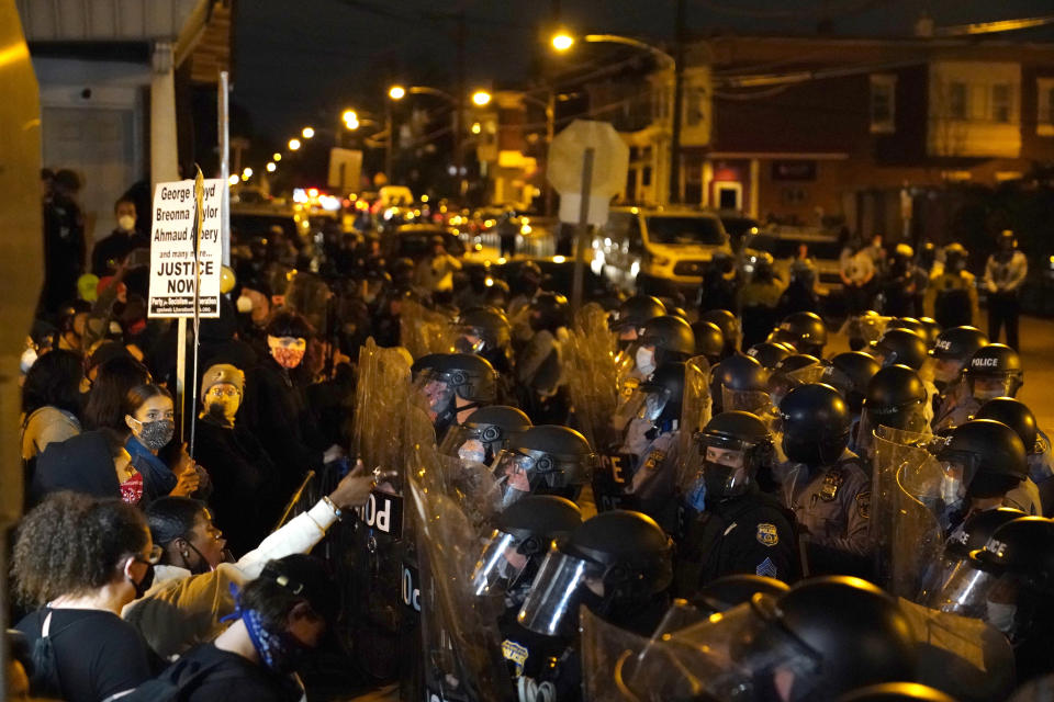 Protesters confront police during a march, Tuesday Oct. 27, 2020, in Philadelphia. Hundreds of demonstrators marched in West Philadelphia over the death of Walter Wallace, a Black man who was killed by police in Philadelphia on Monday. Police shot and killed the 27-year-old on a Philadelphia street after yelling at him to drop his knife. (AP Photo/Matt Slocum)