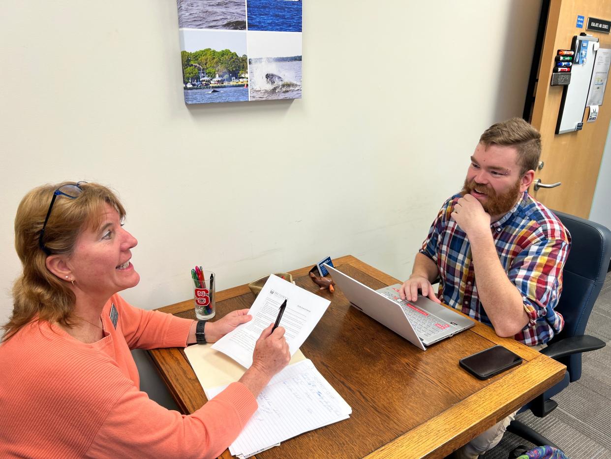 Dr. Kim Jones talks with Lucas Merriam about upcoming Science Club events insider her office at Brunswick Community College on Thursday, Feb. 15, 2024. Jones, a science instructor, currently serves as the advisor to the science club and Merriam is the president.