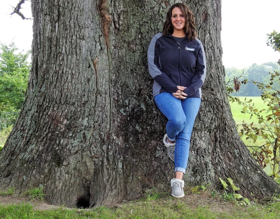 Andrea Wentz of Echoing Hills Village at a large tree that is one of her favorite places on the Echoing Hills campus.