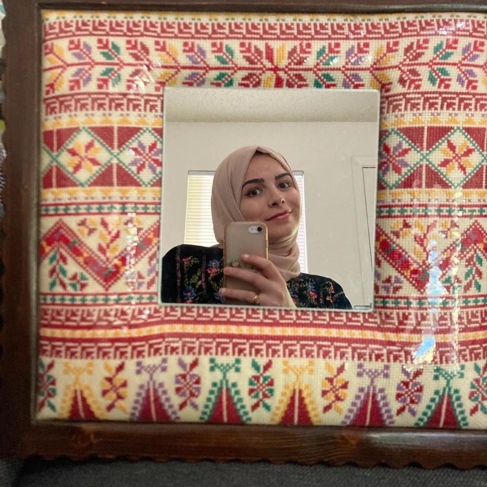 Afnan Isleem Algharabli seen in one of her embroidery-framed mirrors.