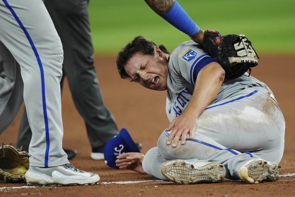 Kansas City Royals relief pitcher Austin Cox winces after an injury during the seventh inning of the team's baseball game against the Toronto Blue Jays on Friday, Sept. 8, 2023, in Toronto. (Nathan Denette/The Canadian Press via AP)