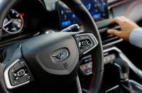 The logo of Chinese automaker Kaiyi is seen on the steering wheel of a car at a dealership in Lyubertsy