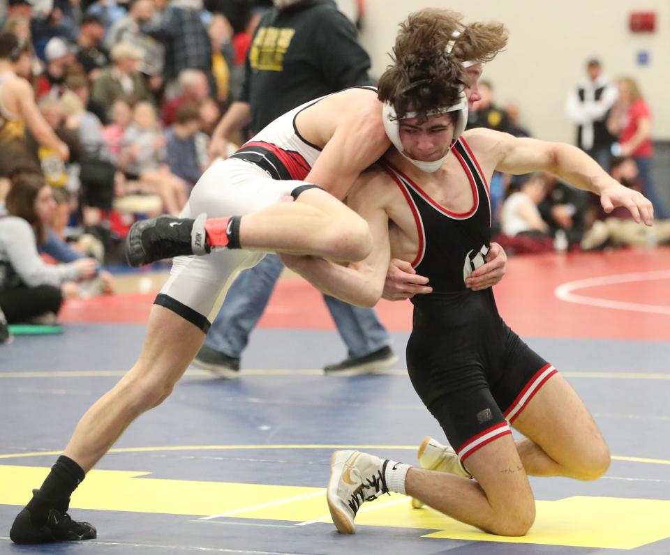 Crestwood's John Wrobel, right, makes a move on Perry's Riley Rowan in the finals of the 126 pound weight class at the OHSAA Division III District Wrestling Tournament at Independence High School on Saturday March 2, 2024.
