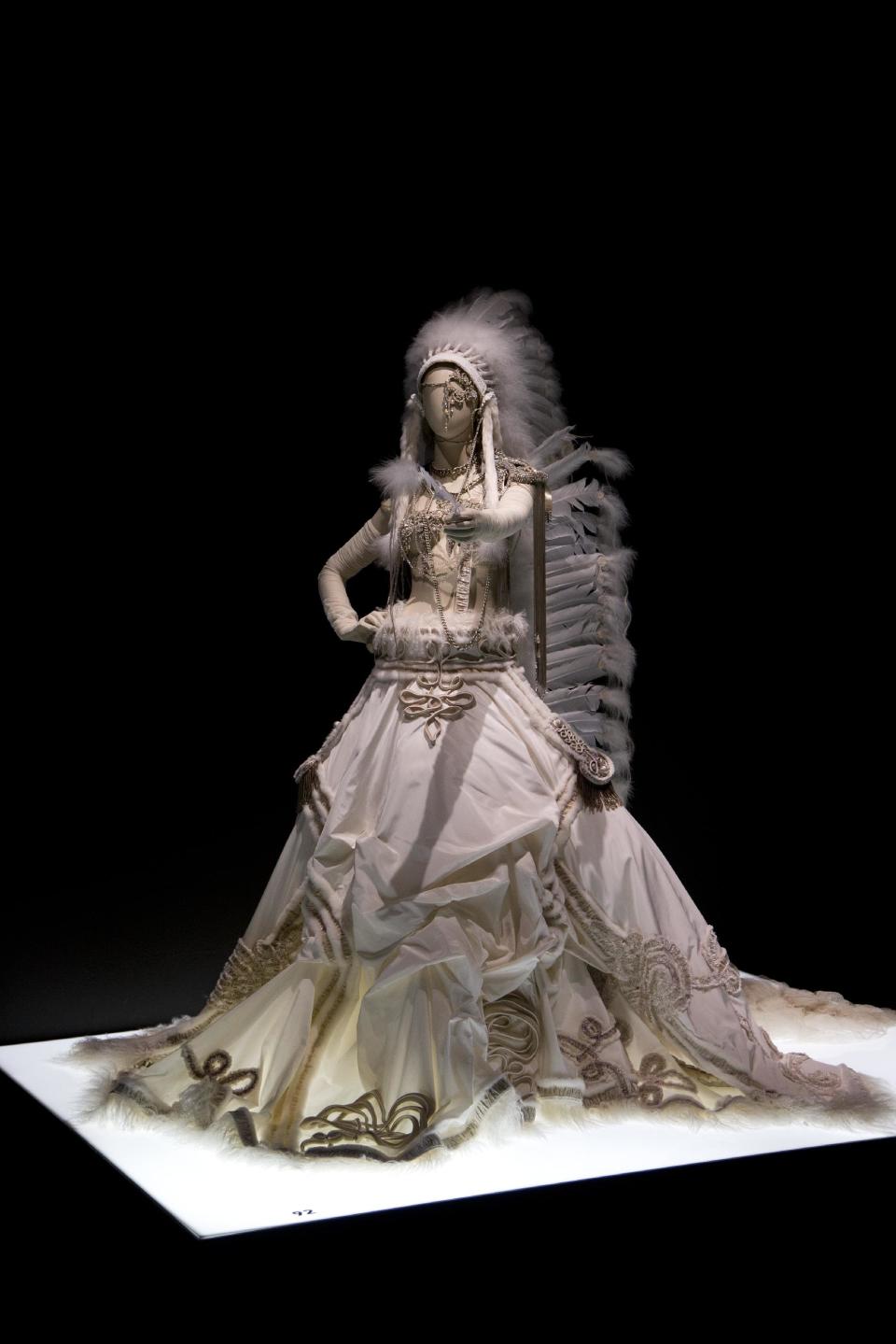 A wedding dress by French fashion designer Jean Paul Gaultier is displayed at the opening of his exhibit "The Fashion World of Jean Paul Gaultier", from the sidewalk to the catwalk, at Kunsthal museum in Rotterdam, Netherlands, Friday Feb. 8, 2013. The exhibit opens to the public on Feb. 10, 2013. (AP Photo/Peter Dejong)