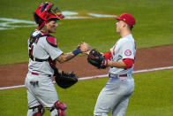 St. Louis Cardinals relief pitcher Ryan Helsley, right, celebrates with catcher Yadier Molina after the first baseball game of the team's doubleheader against the Pittsburgh Pirates in Pittsburgh, Friday, Sept. 18, 2020. The Cardinals won 6-5. (AP Photo/Gene J. Puskar)