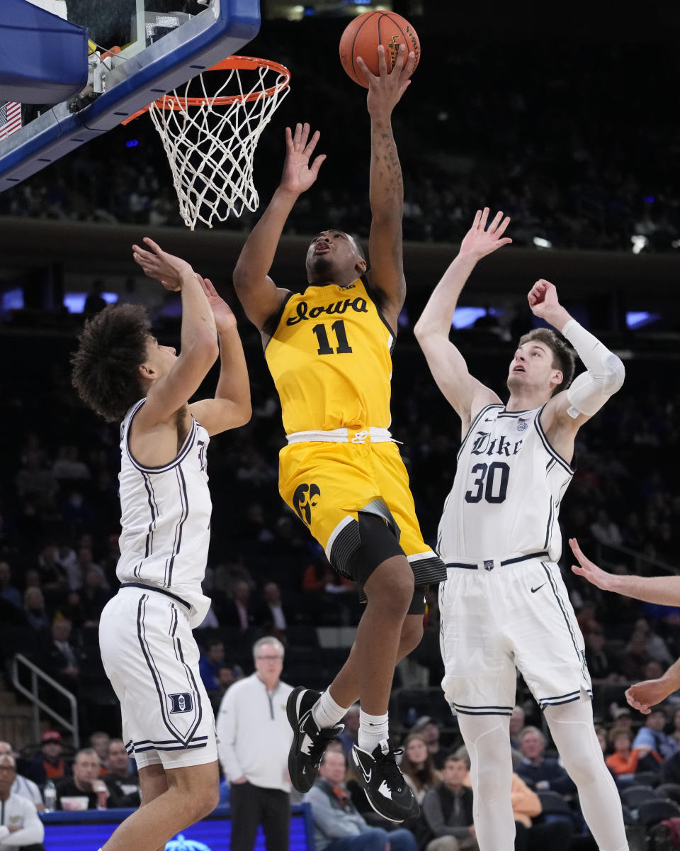 Iowa's Tony Perkins (11) shoots against Duke's Kyle Filipowski (30) during the second half of the team's NCAA college basketball game in the Jimmy V Classic, Tuesday, Dec. 6, 2022, in New York. (AP Photo/John Minchillo)