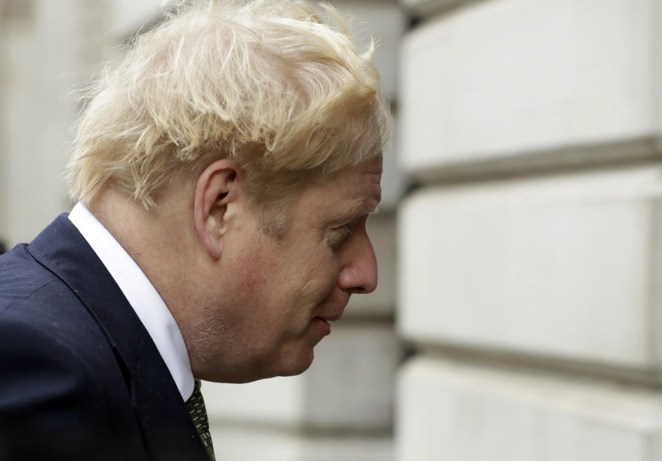 British Prime Minister Boris Johnson walks from 10 Downing Street to a meeting with his ministers at the Foreign Office, in London, Friday, Oct. 23, 2020. (AP Photo/Matt Dunham)