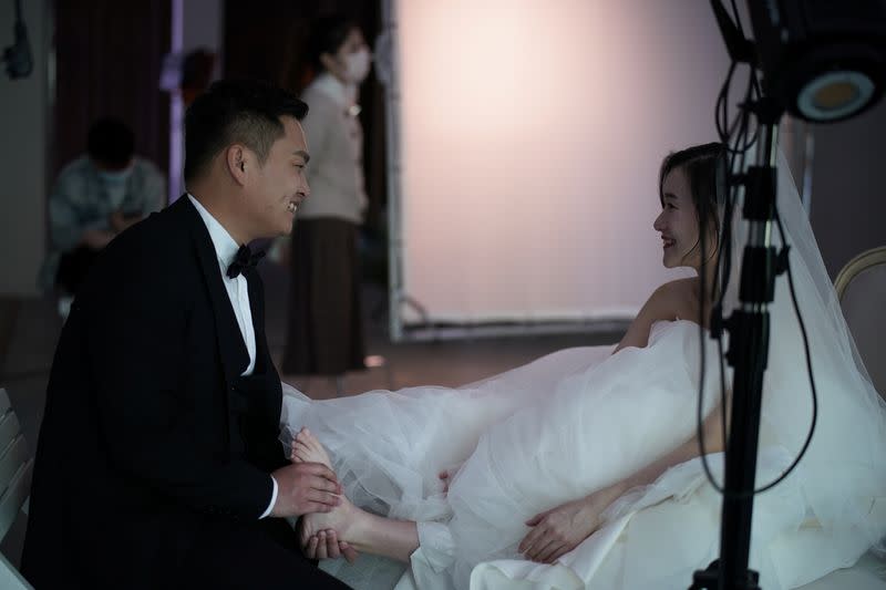 Yao Bin, 28, gives a foot massage to Peng Jing, 24, during their wedding photography shoot after the lockdown was lifted in Wuhan