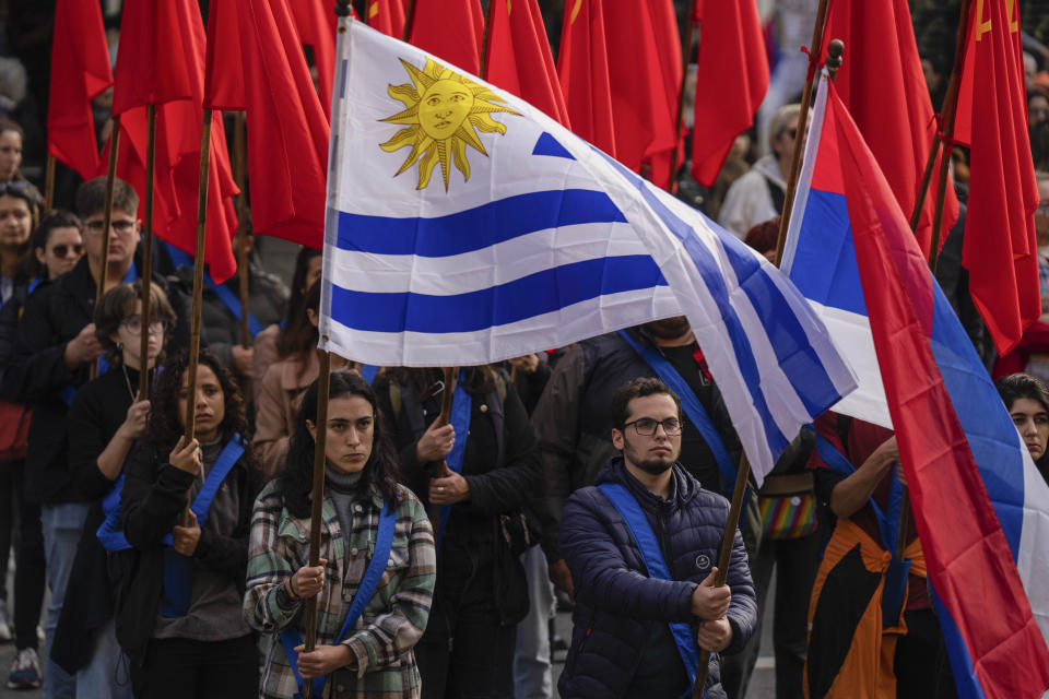 Members of the Uruguayan Communist Party hold a tribute to Amelia Sanjurjo during her funeral service held at the University of the Republic in Montevideo, Uruguay, Thursday, June 6, 2024. The Uruguayan Prosecutor’s Office confirmed that human the remains found in June 2023 at the 14th Battalion of the Uruguayan Army belong to Sanjurjo, a victim of the 1973-1985 dictatorship who was 41 years old and pregnant at the time of her disappearance. (AP Photo/Matilde Campodonico)