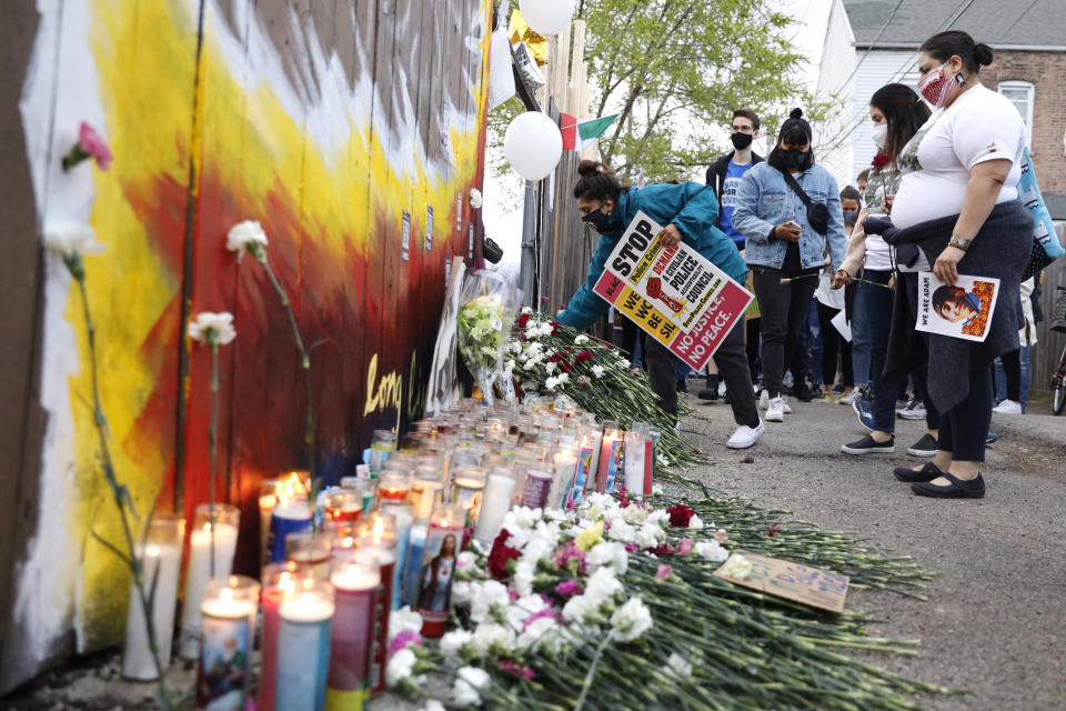 People pay tribute as they attend a peace walk honoring the life of police shooting victim 13-year-old Adam Toledo, Sunday, April 18, 2021, in Chicago's Little Village neighborhood. (AP Photo/Shafkat Anowar)